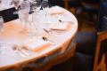 Gedeckter Restauranttisch als Symbol für Bewirtungskosten, Spesenbetrug und Abrechnungsbetrug in Unternehmen